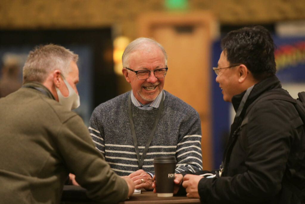 Three attendees chatting at the SSA's Annual Meeting 2022